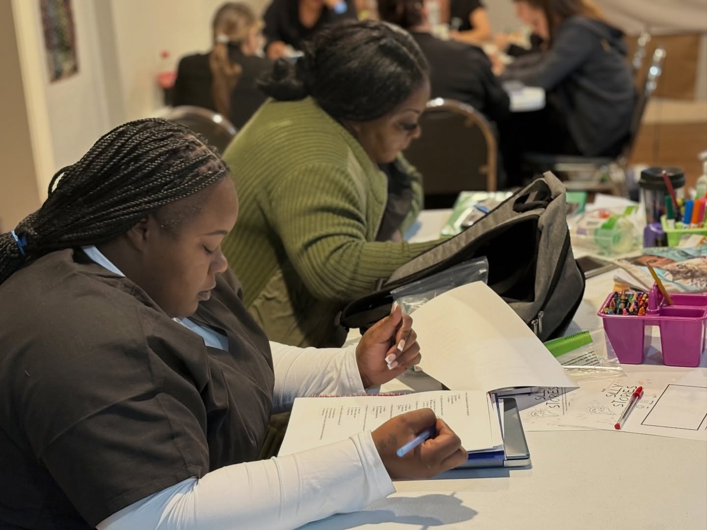 VMI students in scrubs seated at tables studying course materials during a classroom session